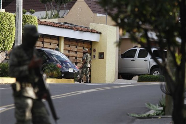 Soldiers guard a street in the area where, according to Mexico's Defense Minister, Mexican drug cartel leader Ignacio Coronel Villareal, aka Nacho Coronel was killed during an army raid in Zapopan, near Guadalajara, Mexico, Thursday, July 29, 2010. Coronel is considered number three in the organization of fugitive Mexican drug lord Joaquin Chapo Guzman. (AP Photo/Claudio Cruz)